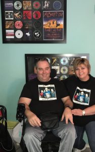 john and madie in front of oils cds photo and we present our wheelchair travel tips