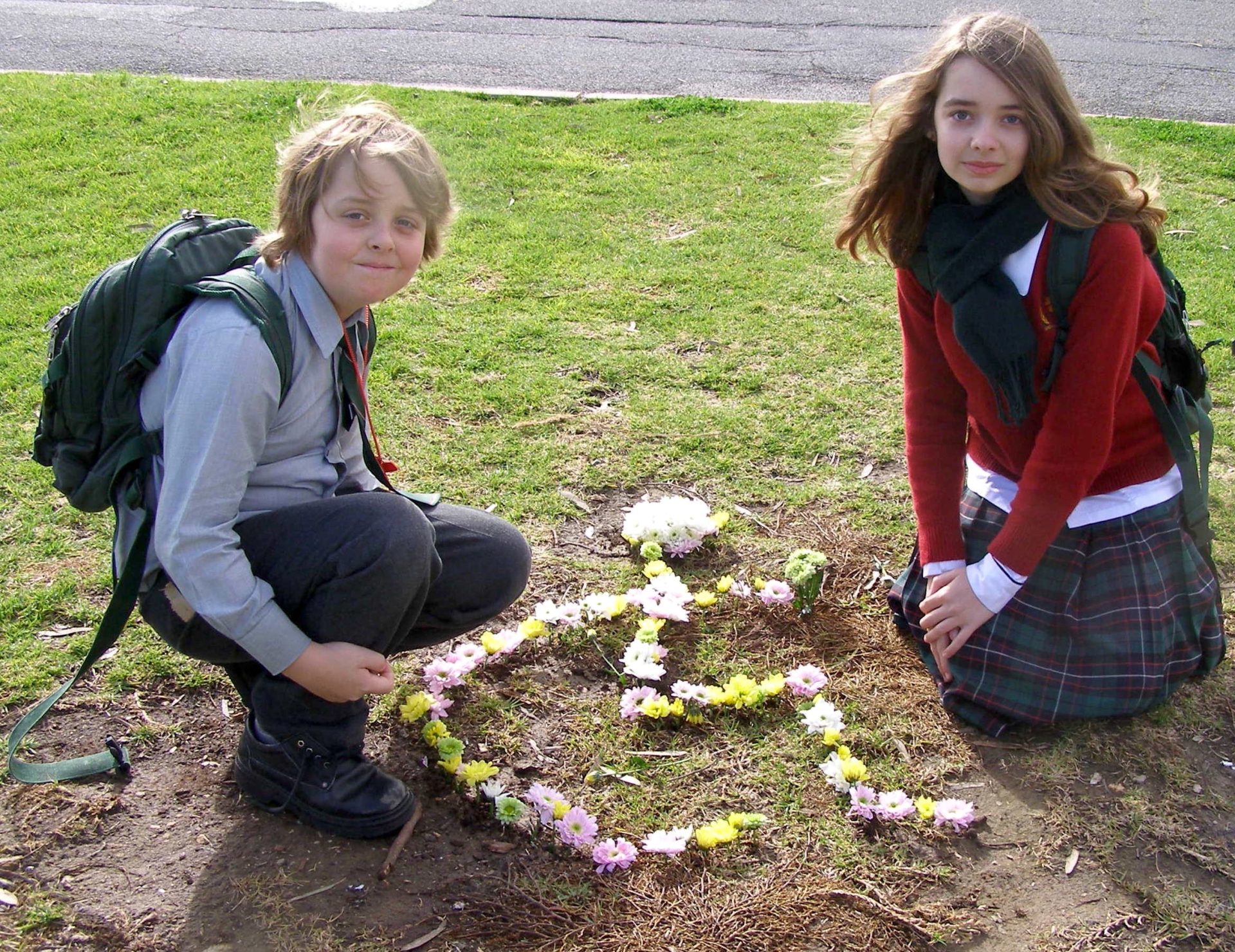 a pretty collection of flowers in the shape of a wheelchair and ben and jasmine on the anniversary of the accident