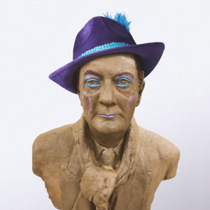 an ugly bust of peter goers (accurate though) wearing a purple hat. Adelaide Fringe Accessibility