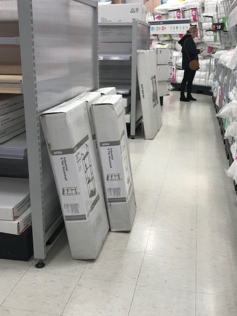 At Kmart there are 2 rows shown. Normally there is room for wheelchairs to get around, but the photo shows large boxes blocking access. Scentre Group accessibility needs to improve