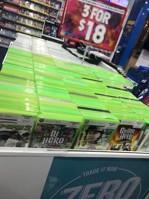 The green cases with games for sale are tightly packed, and too high to view in a wheelchair.