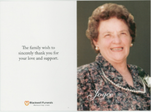 The memorial card of Joyce Dorothy Duthie. It shows a photo of Joyce with a big smile, and pearl necklace, taken at the wedding of her son. It reads 'The family wish to sincerely thank you for your love and support'