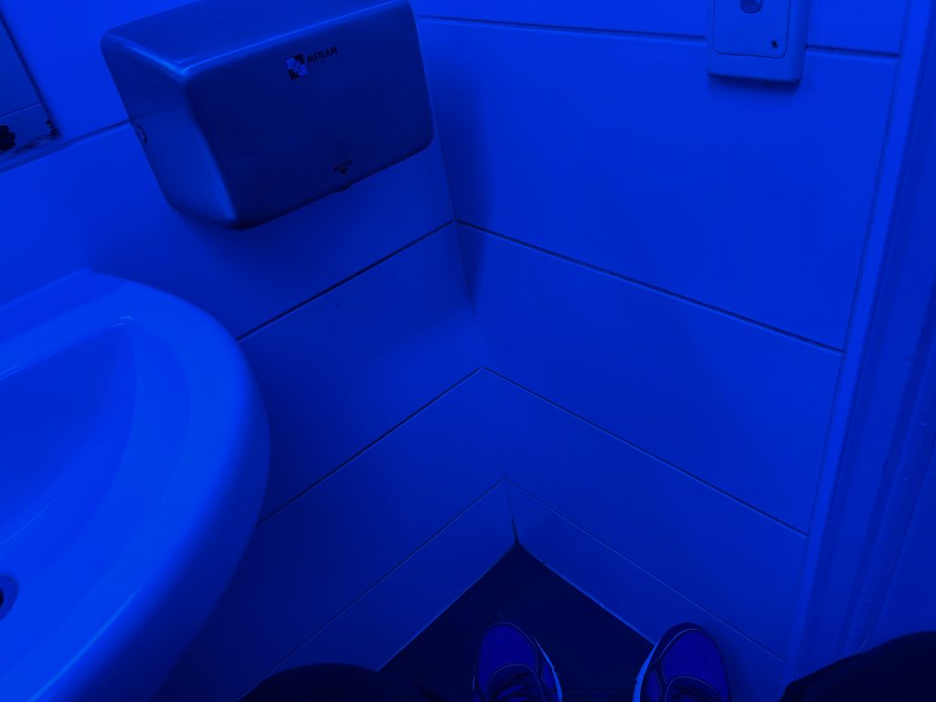 its all blue, hand basin left, hand dryer in middle then the door to the right