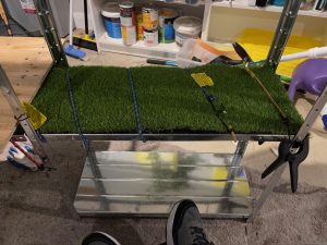 Use plenty of glue that is waterproof to stick the fake grass to metal to allow you to build a cat tower