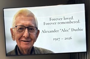 How to use ChatGPT to write a eulogy - Memorial screen displaying a portrait of Alexander "Alec" Duthie before his funeral service in Adelaide.